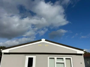 Park home beneath a cloudy sky - new fascia and guttering