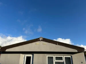 Clear sky above a parkhome rotten fascia