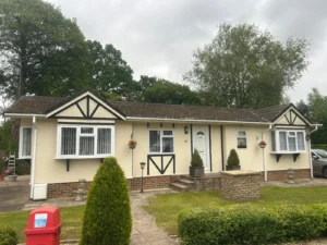 Charming bungalow style park home with landscaped garden before being repainted.